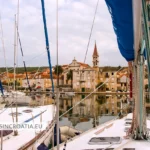 Sailing boats in a quiet harbor on a Croatian island town on the Adriatic coast